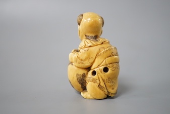 A Japanese ivory netsuke of boy and puppy, Meiji period, signed 4cm